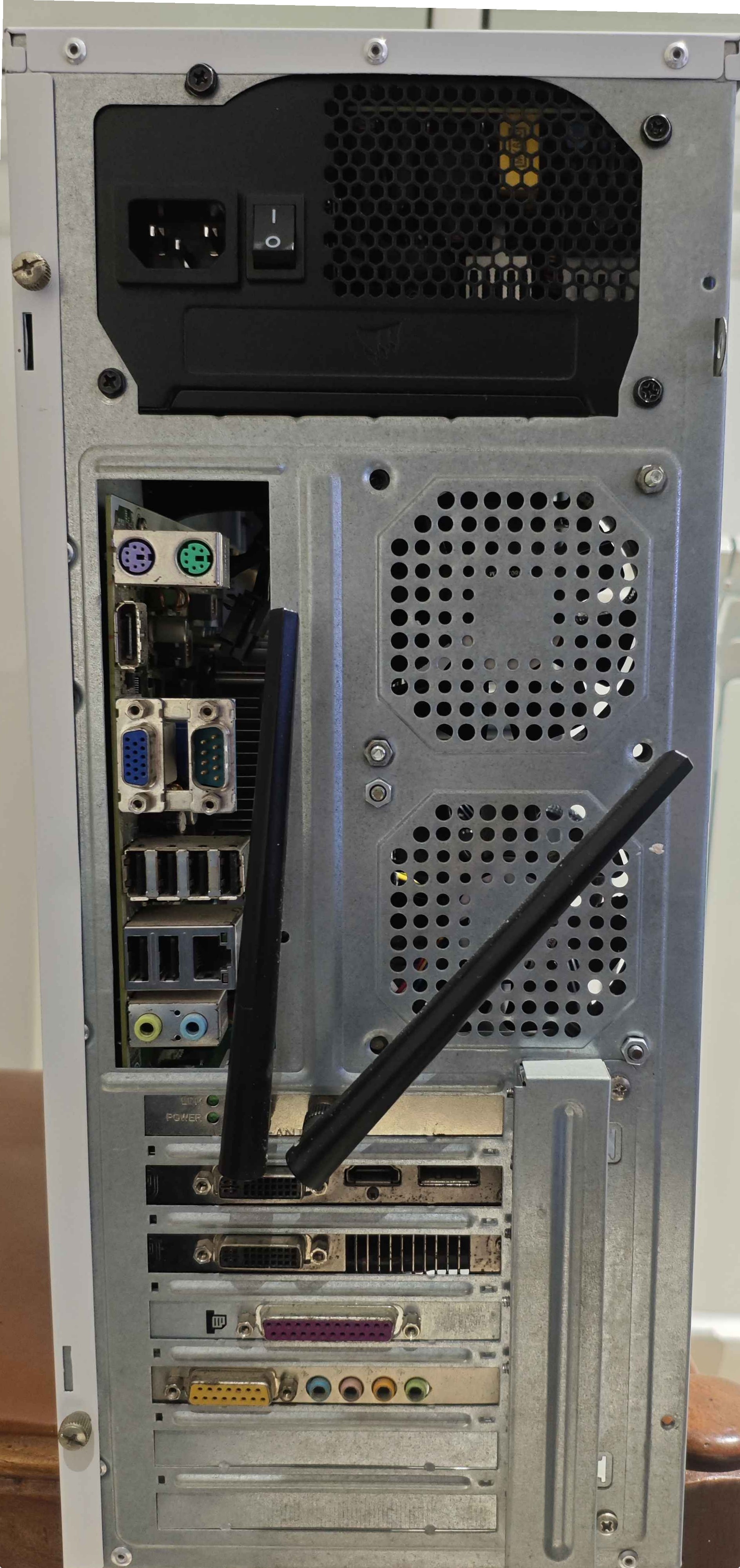 Back view of the desktop, showing rear I/O: PS/2, two display ports, two DVIs, HDMI, VGA, serial, six USB ports, parallel port, game port, and audio jacks